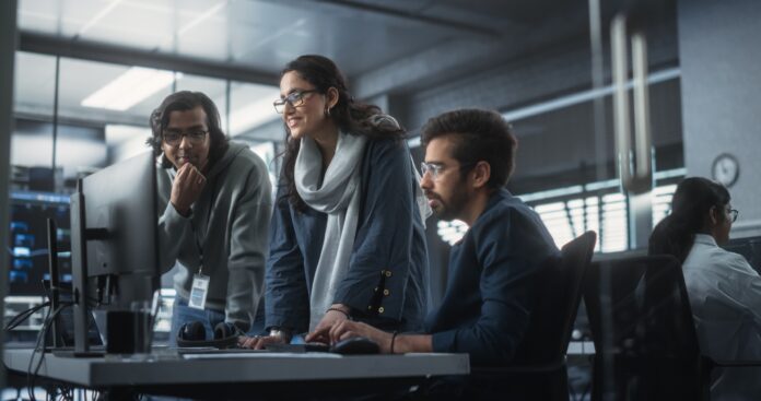 Group,Of,Three,Young,Indian,Software,Engineers,Use,Computer,To
